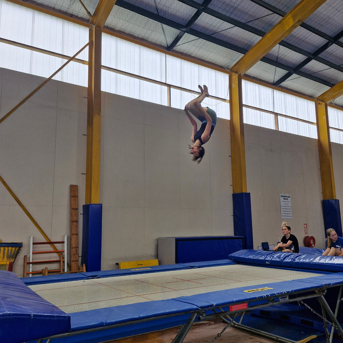 Girl doing a back flip on the trampoline